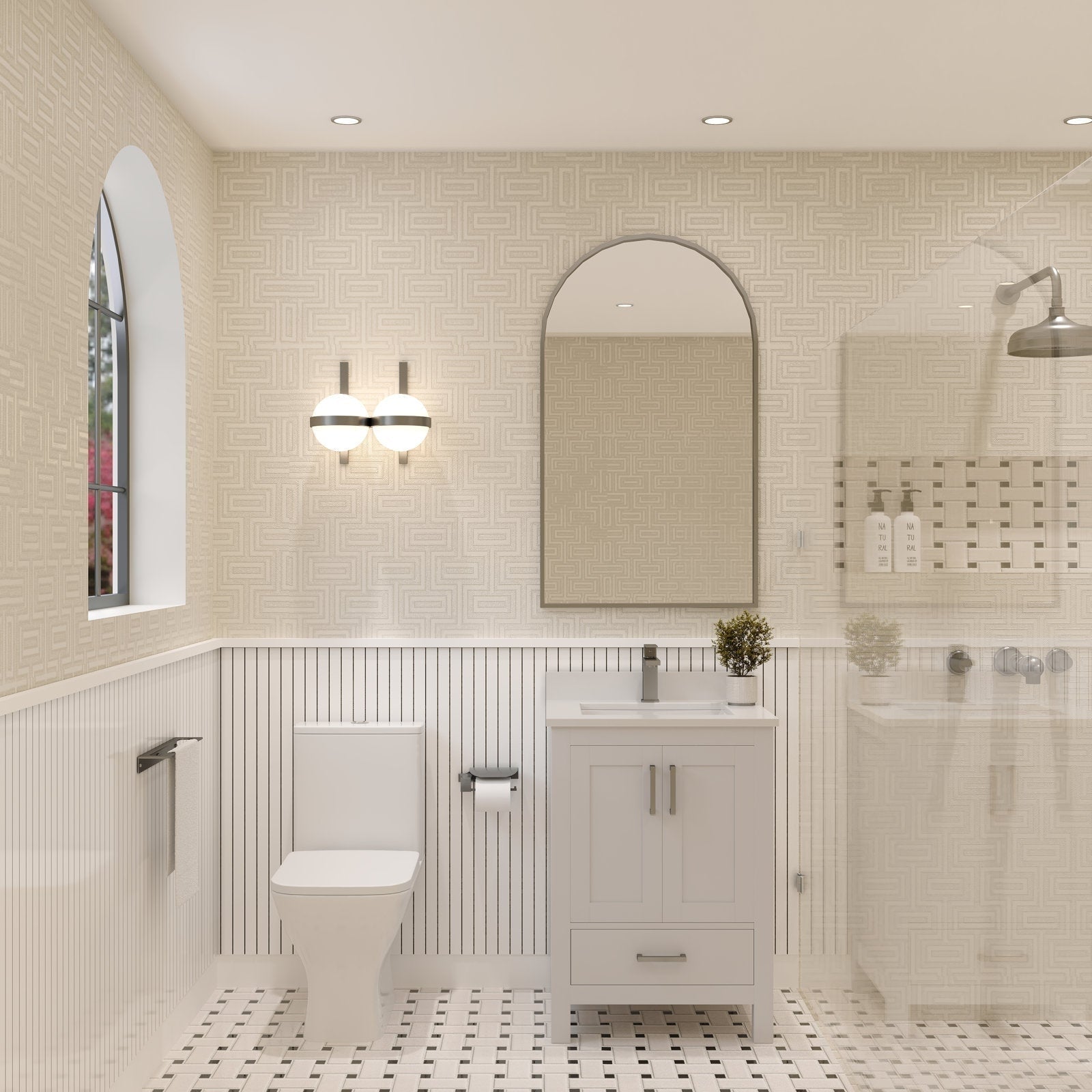 Freestanding 24-inch stone-colored solid wood bathroom vanity with ceramic sink and stone top, single matte metal faucet, arched mirror and globe wall sconce above; toilet to left and glass shower to right.
