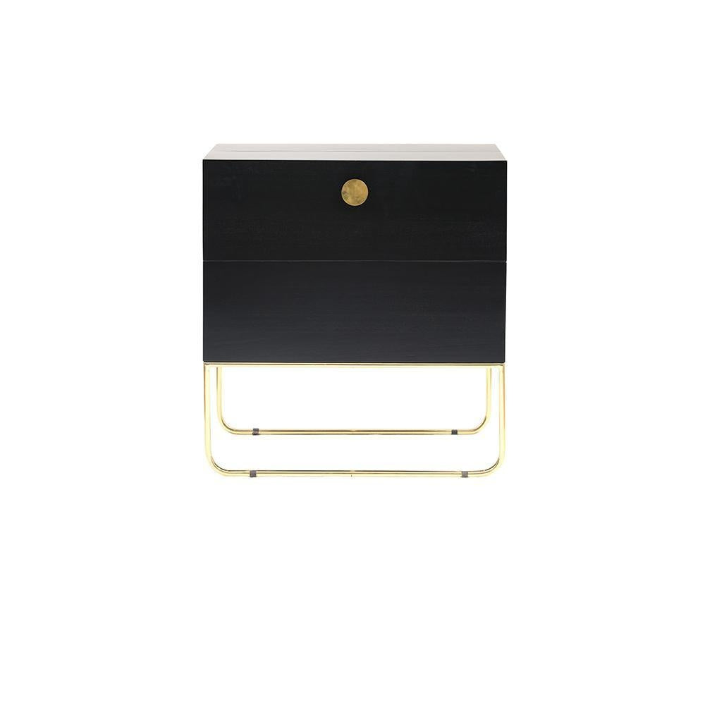 Front view of a mahogany drinks cabinet with a centered round brass knob, two stacked drawers and a polished brass sled-style base in a contemporary glam silhouette on a white background.
