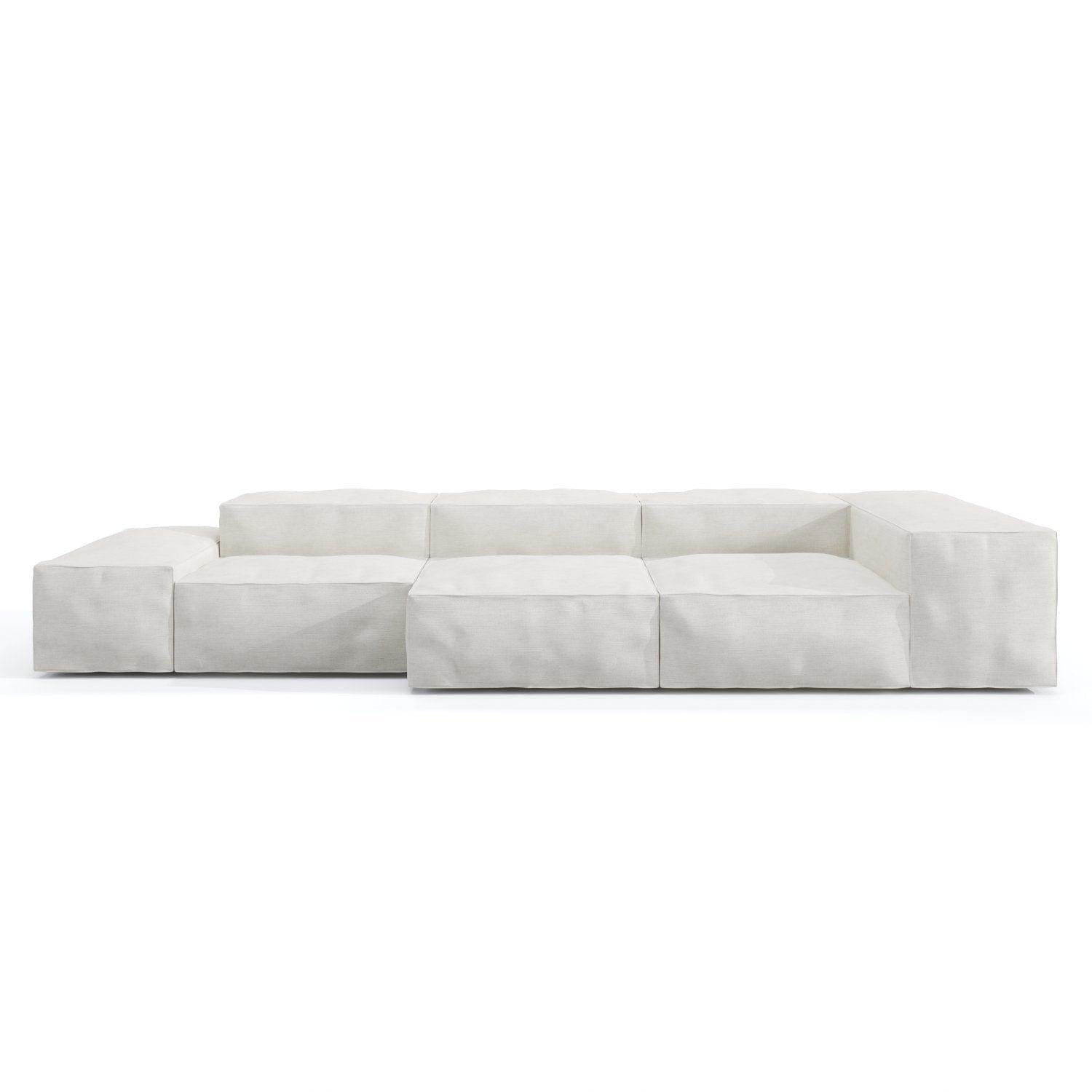 Low-profile modular sofa upholstered in loose white linen with deep cushioned block seats, wide low arms and a subtle wooden base, shown against a plain white background.
