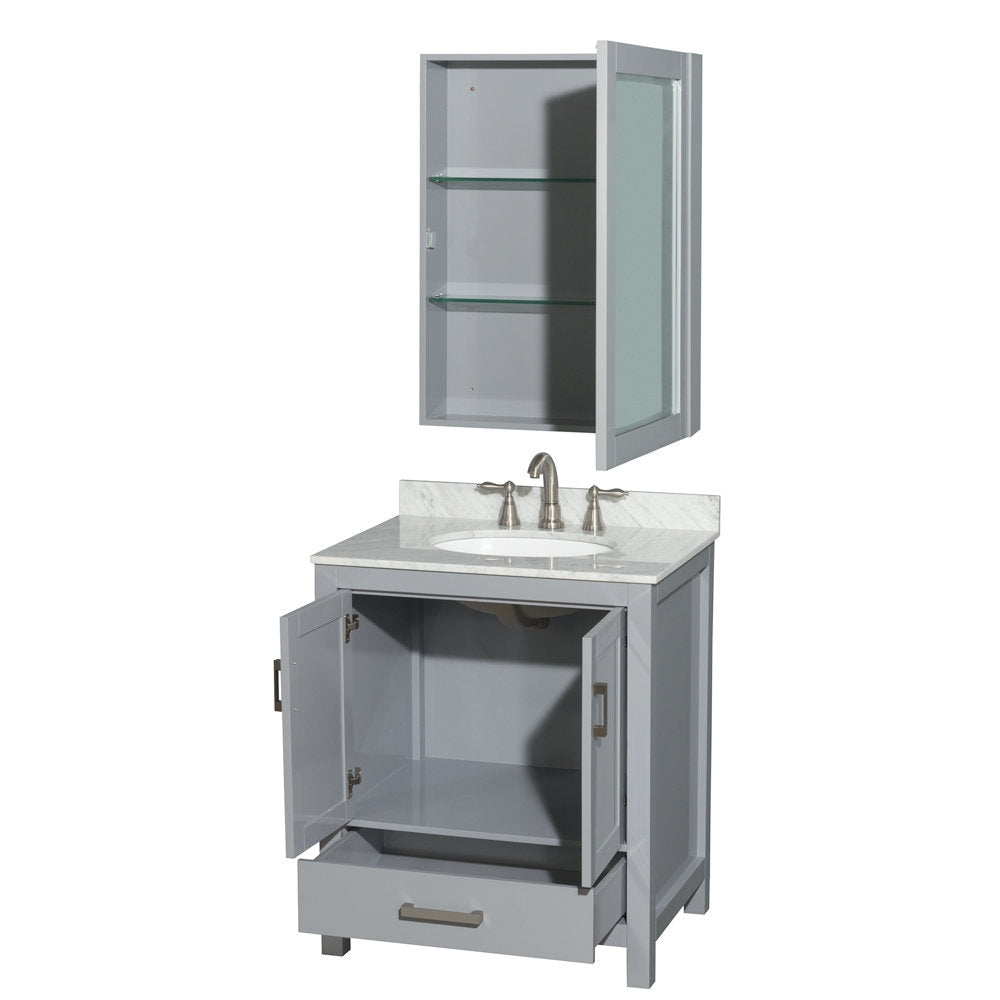 Modern gray solid-wood bathroom vanity with a stone countertop and integrated white ceramic sink, brushed-nickel faucet, open lower cabinet and drawer, plus a matching wall-mounted medicine cabinet with glass shelves.