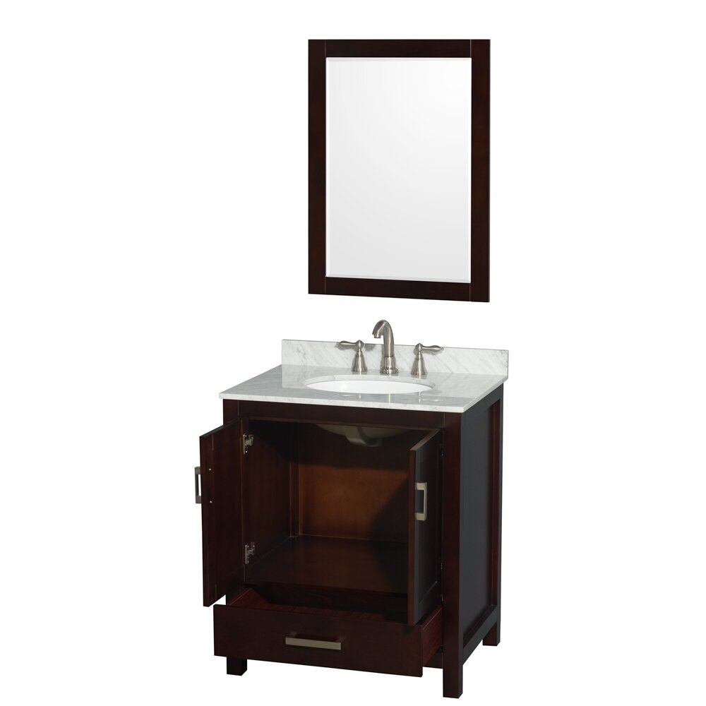 Modern freestanding solid wood bathroom vanity in dark finish with stone countertop and undermount white ceramic sink, brushed nickel faucet, open double-door cabinet and lower drawer, paired with a matching framed mirror.