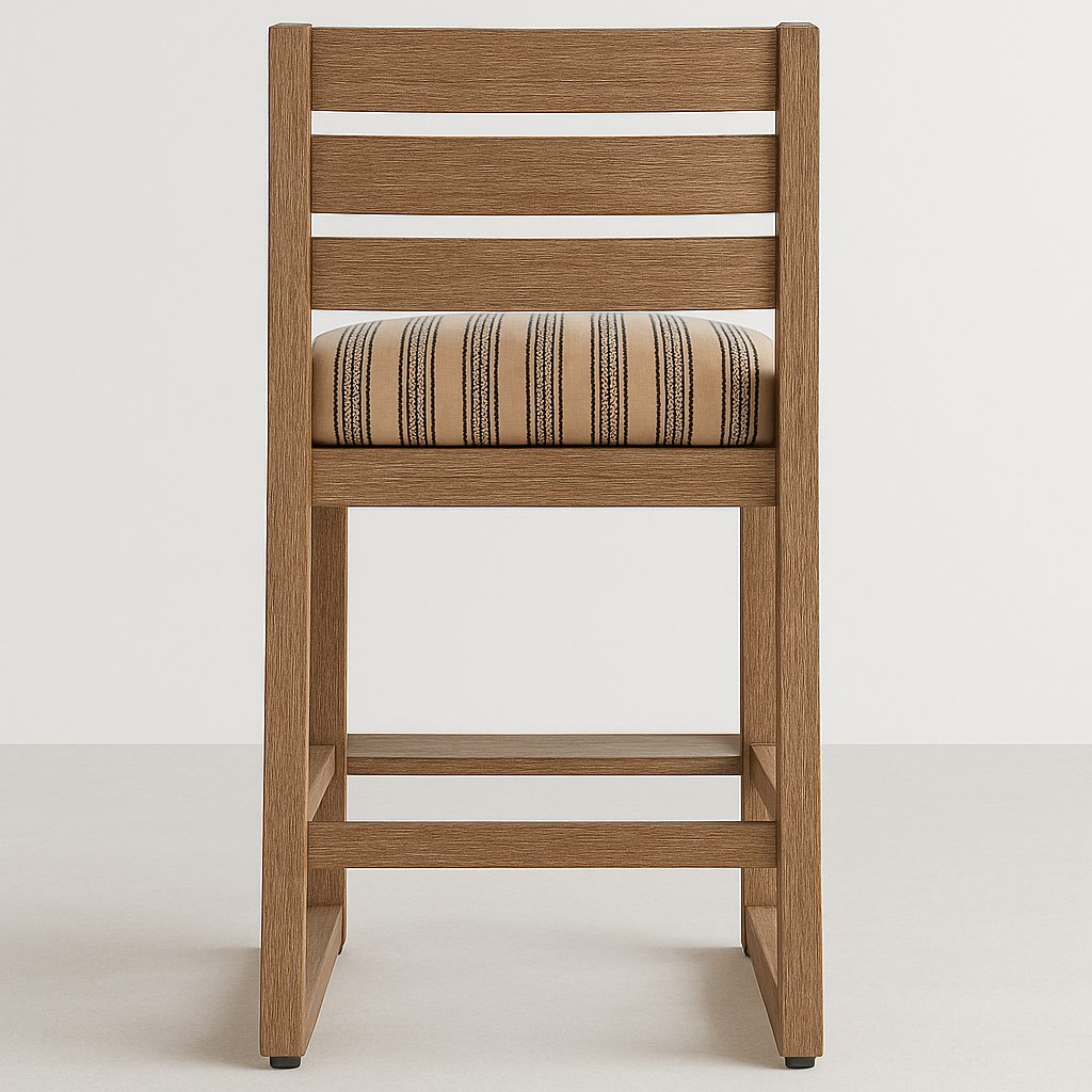 Front view of an armless teak outdoor bar stool with a horizontal slatted back and a cushioned striped seat on a teak frame with integrated footrest, coastal contemporary styling.