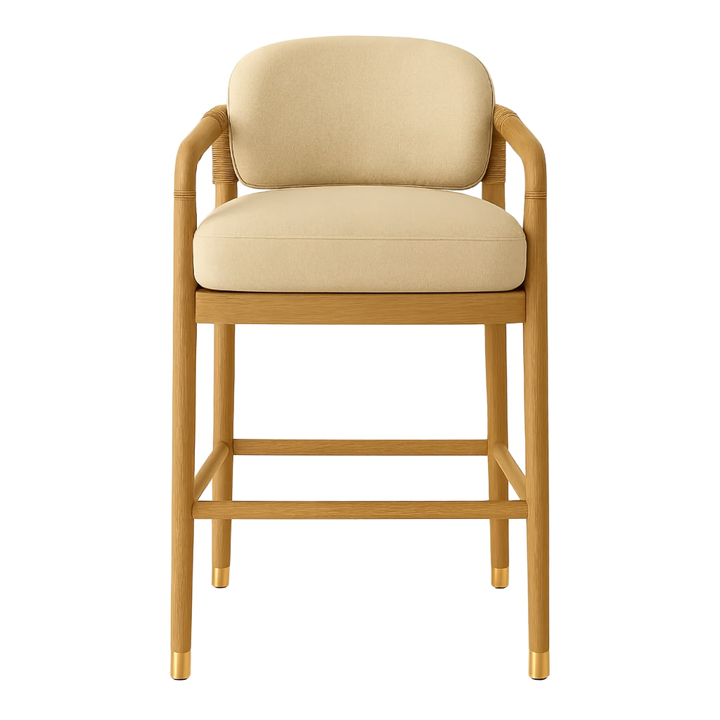Front view of a natural teak bar stool with beige upholstered seat and rounded back, rope-wrapped arm details and brass-tipped legs in a modern coastal Scandinavian style.