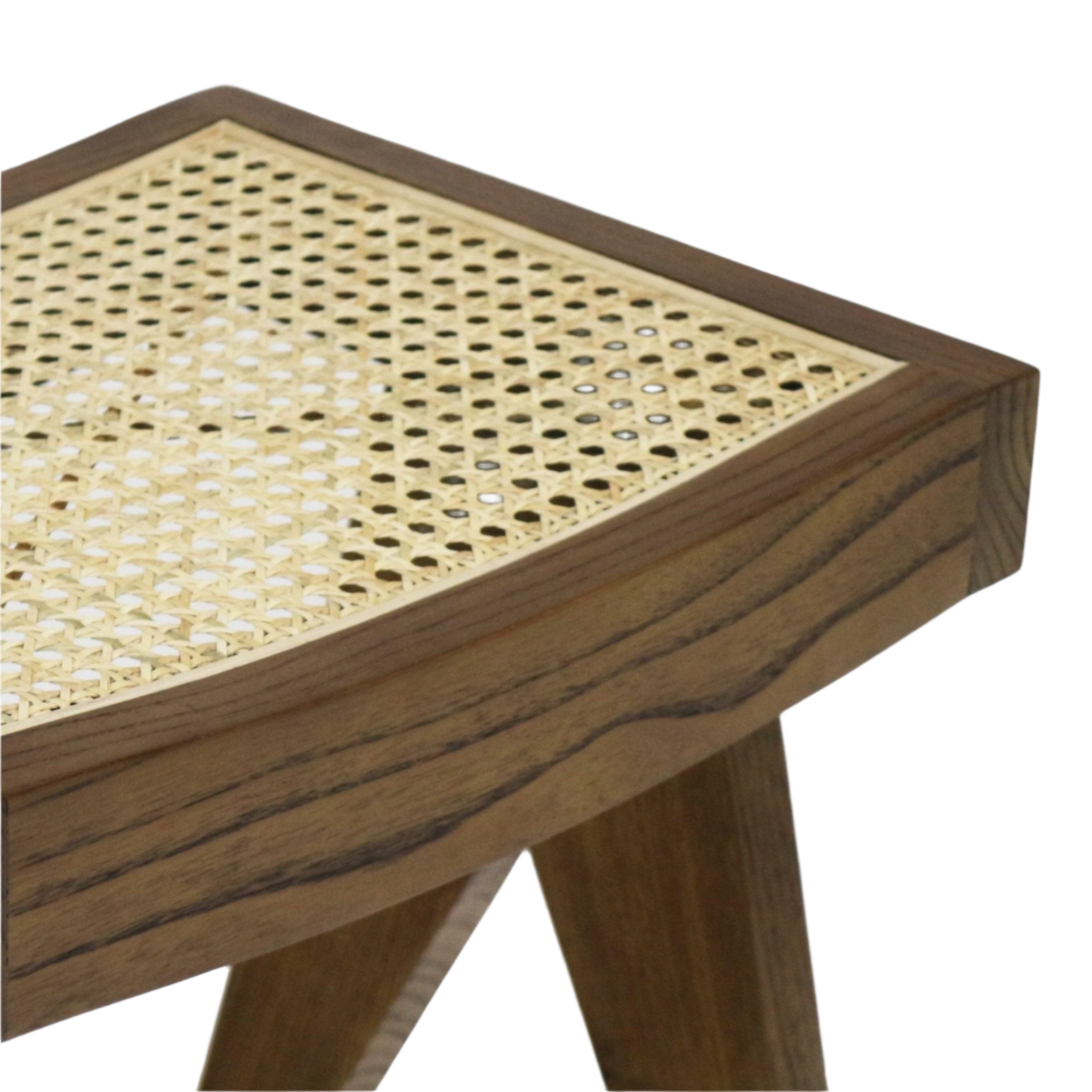 Close-up of a natural wood footstool showing a woven cane top, visible wood grain on the frame and angled tapered legs in a mid-century modern style with a natural finish.