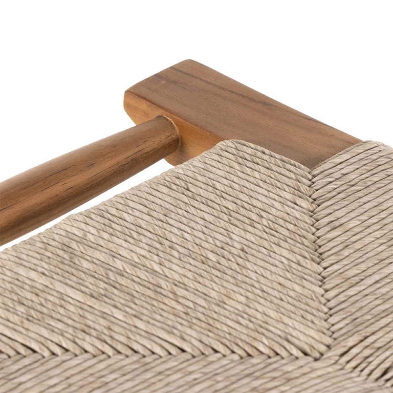 Close-up of a natural teak rail and tightly woven beige rope seat in a chevron pattern on a backless outdoor bar stool, highlighting wood grain and handwoven texture.
