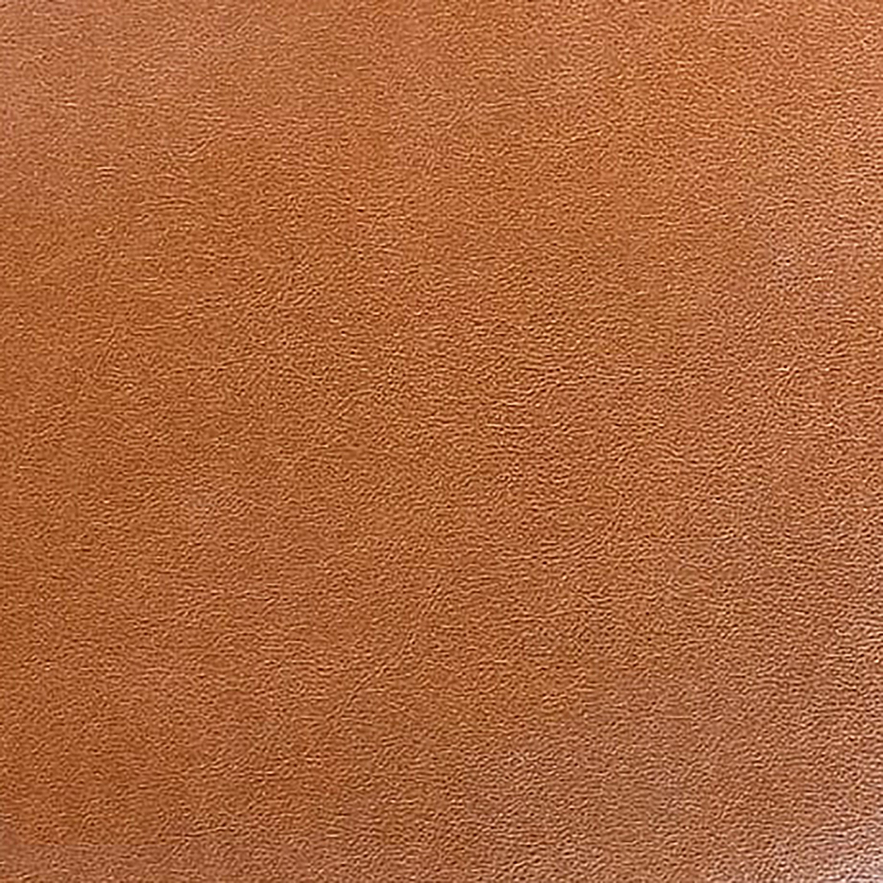 Close-up of warm brown faux leather upholstery showing a subtle pebbled grain texture, pictured as the dining side chair seating material.