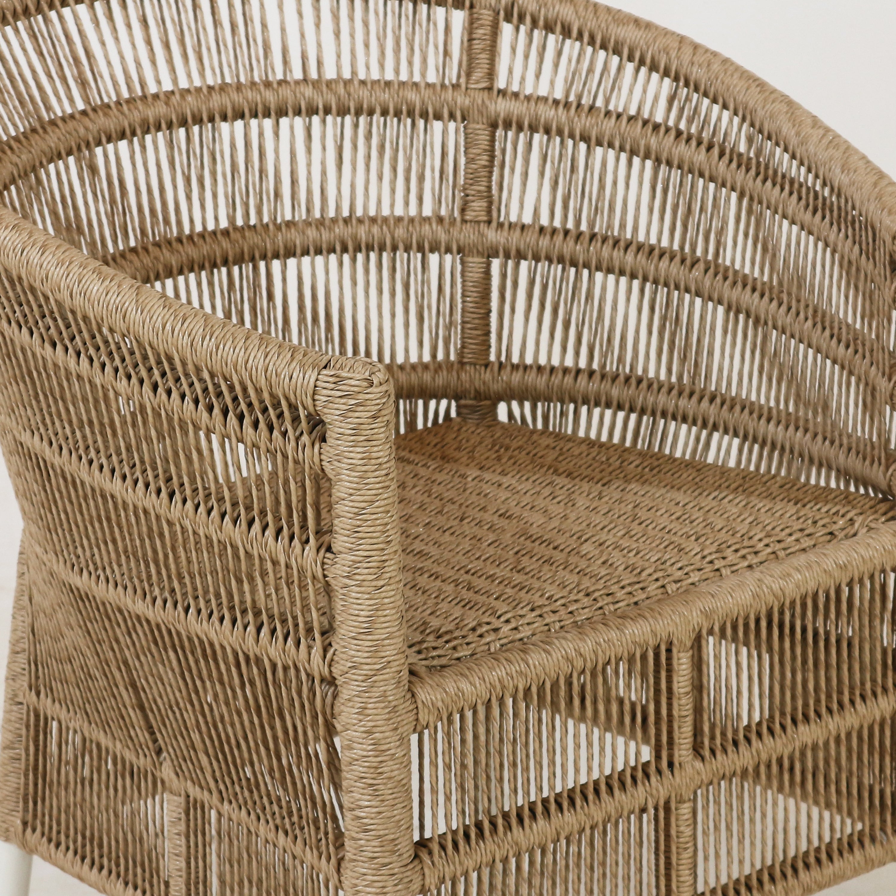 Close-up of a wicker chair with a neutral background. nuema.com Sirena outdoor patio chair