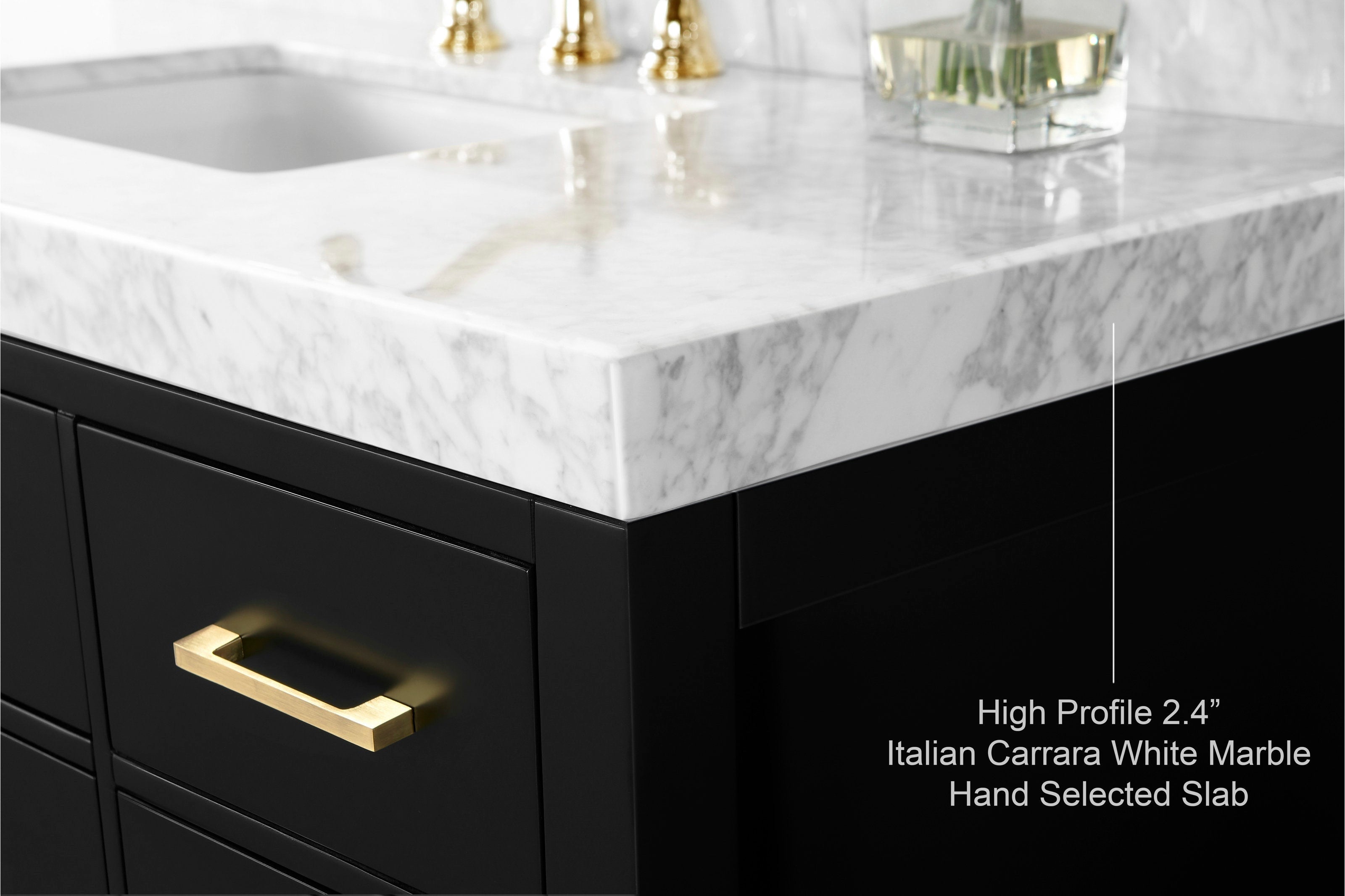 Close-up of a 2.4" Italian Carrara white marble countertop with gray veining on a matte black solid wood vanity, featuring a brass drawer pull and the corner of an undermount sink.