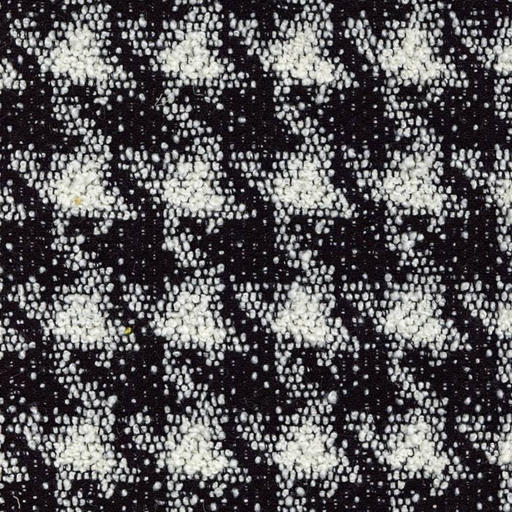 Close-up of black and white boucle upholstery fabric with a textured, houndstooth-like pattern in a wool-acrylic-cotton-polyester blend, shown as a swatch for sofa upholstery.