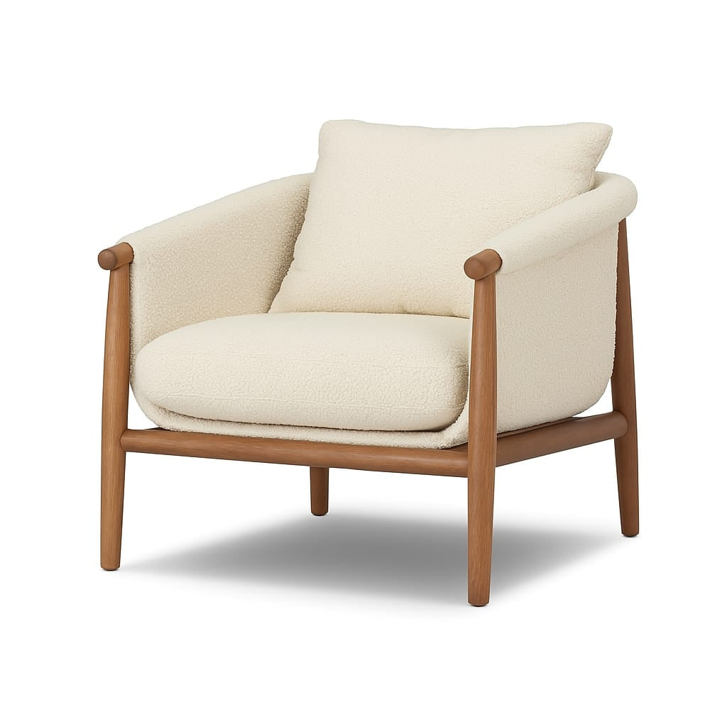 Cream boucle accent chair with plush seat and loose back cushion, rounded padded arms and exposed natural wood frame with tapered legs, shown against a white background.