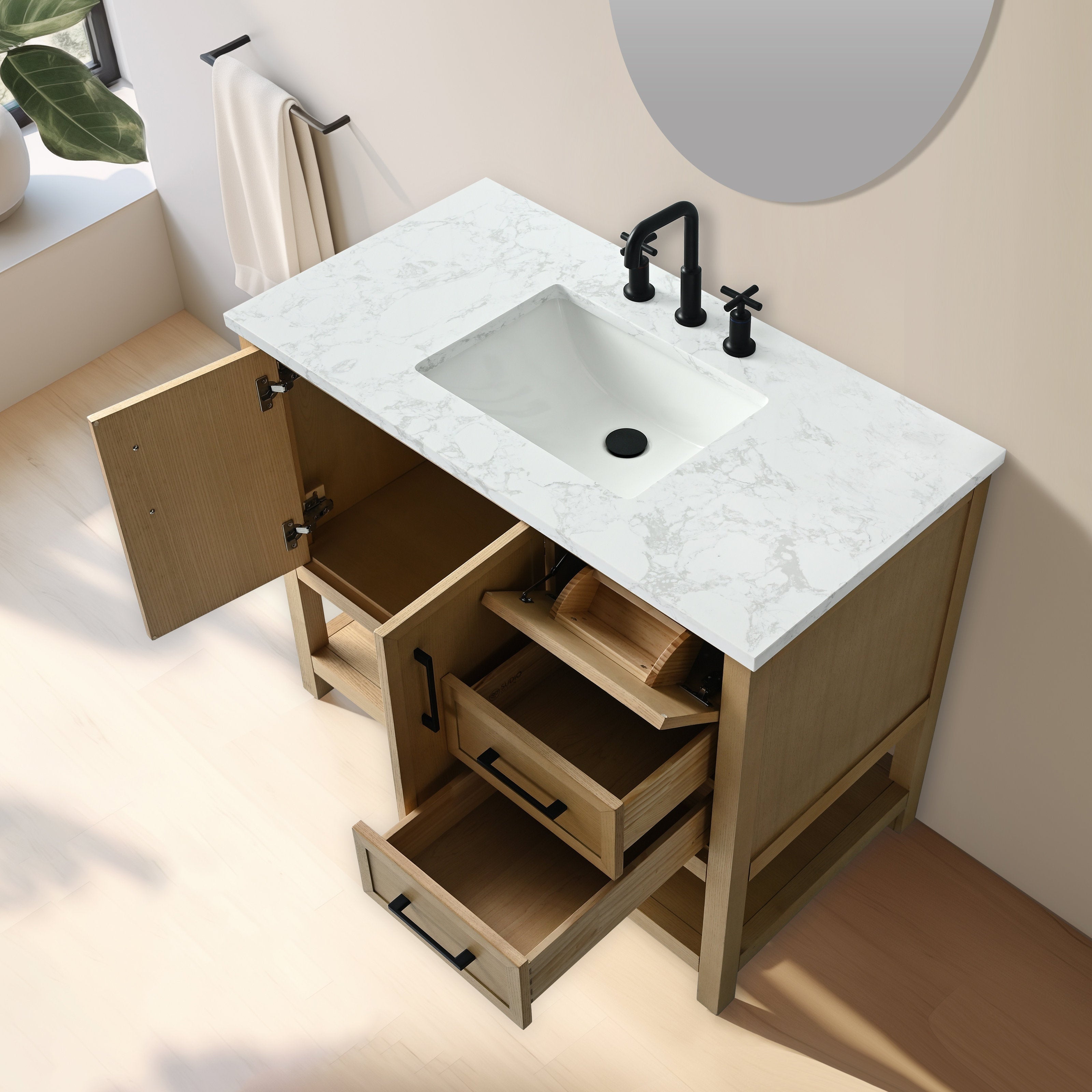 Freestanding single-sink bathroom vanity in light solid wood with a white marble-pattern stone top and integrated rectangular sink, matte black faucet and black handles, shown with open drawers and cabinet.