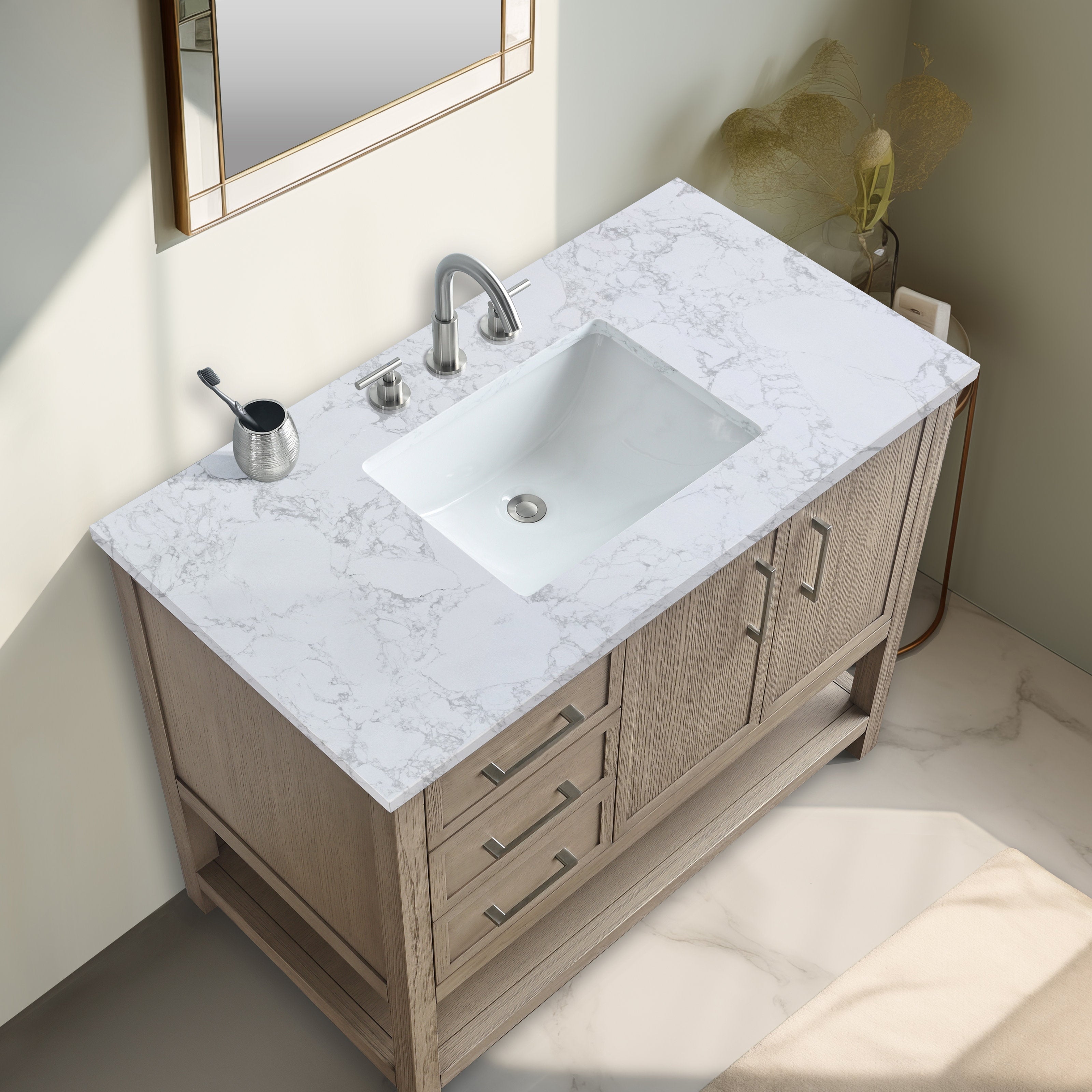 Modern 42-inch solid wood freestanding bathroom vanity in a light wood finish with white marble-look stone top, rectangular undermount ceramic sink, brushed-nickel faucet, metal handles and storage drawers.