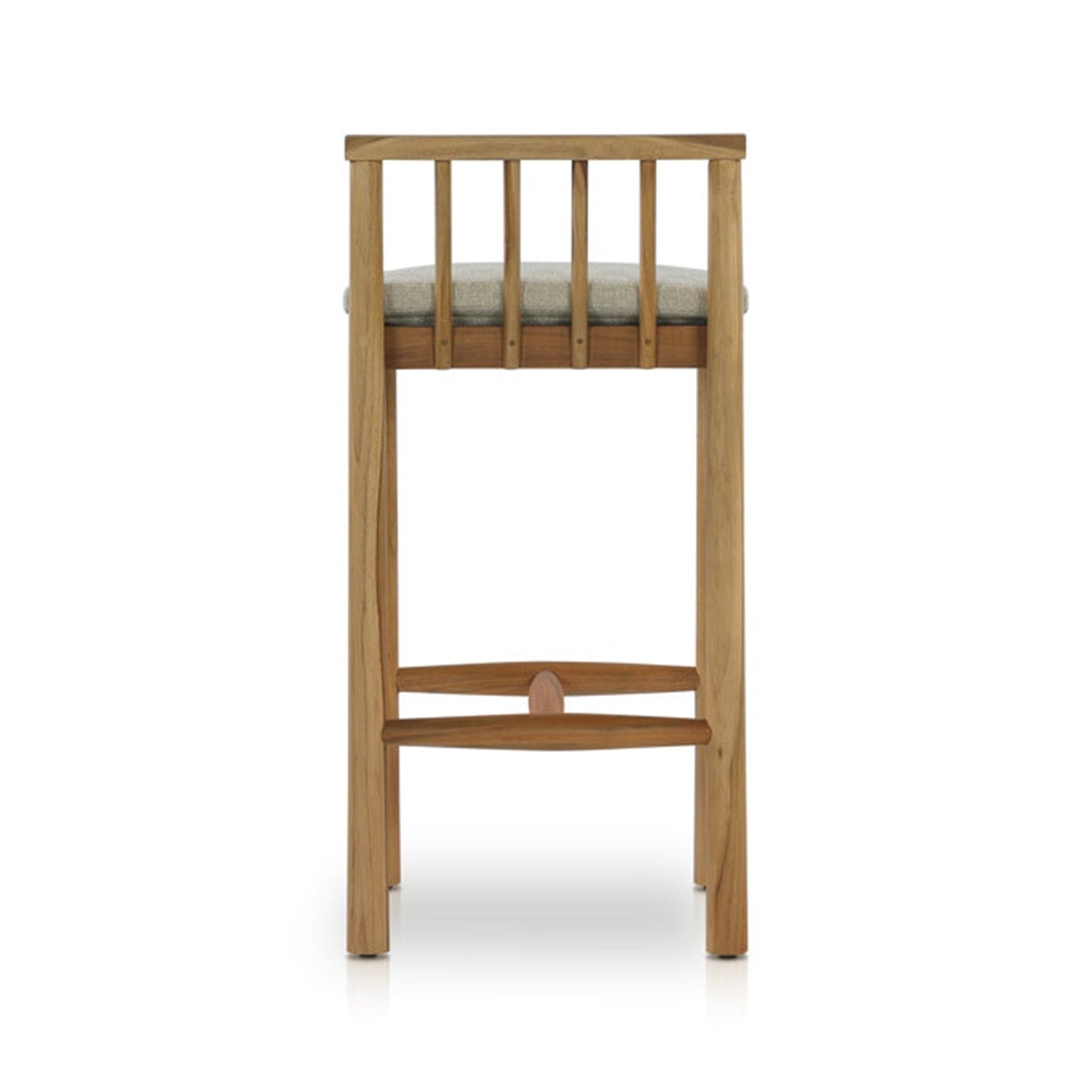 Rear view of an armless outdoor bar stool in natural teak with a light-gray upholstered seat, vertical slatted back and curved teak footrest in a coastal contemporary style.