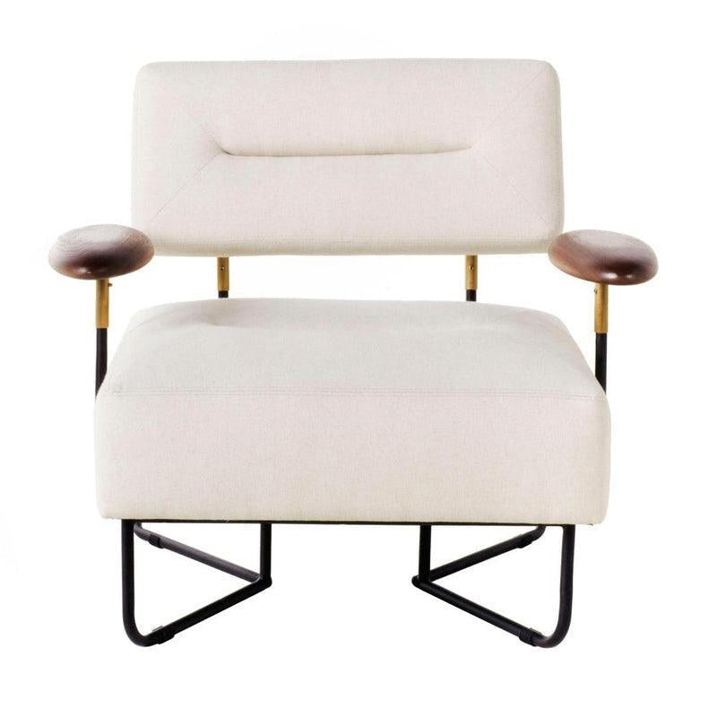 Off-white fabric upholstered low lounge chair with a rectangular padded back and wide cushioned seat, brown wooden arm pads on brass-accented metal supports, and a black metal sled-style base.