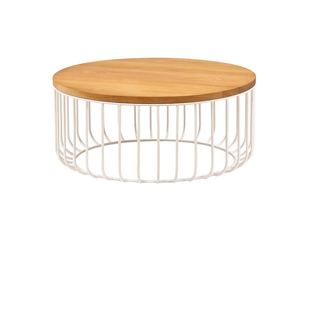 Round teak wood tabletop atop a white iron wire cage base, low rustic coffee table shown on a white background.