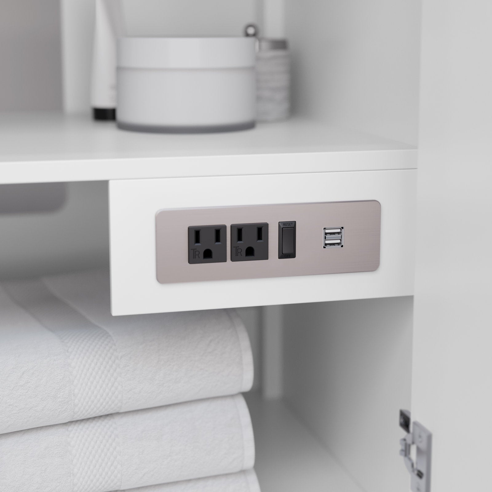 Close-up of a stone-finish outlet plate installed inside a white solid-wood modern bathroom vanity shelf, showing two black power outlets, a reset switch and dual USB ports above neatly folded white towels.
