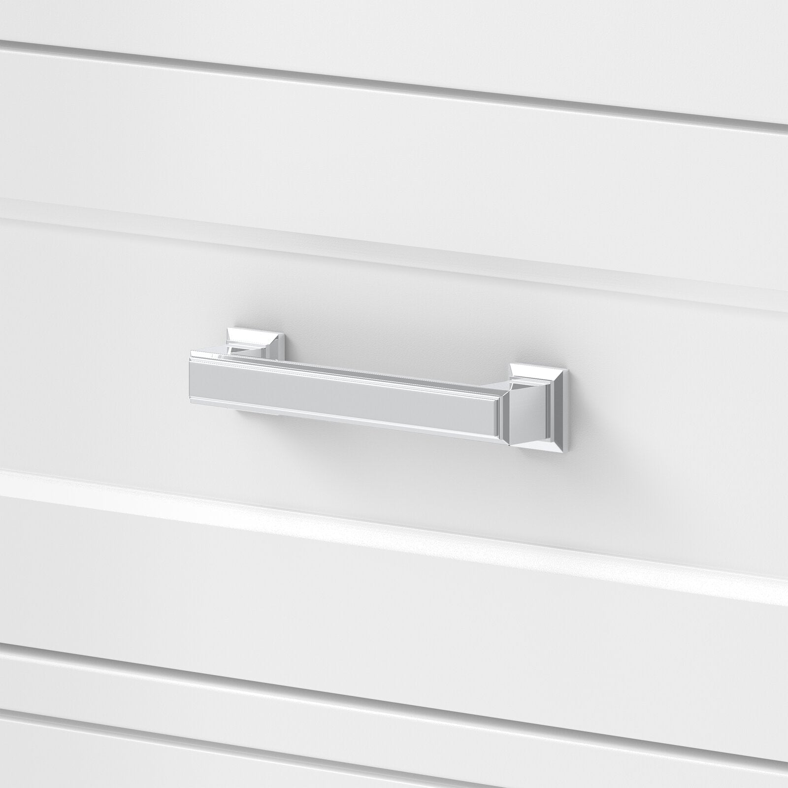 Close-up of a polished chrome rectangular drawer pull with square rosettes mounted on a white solid wood bathroom vanity drawer, showcasing contemporary glam styling.