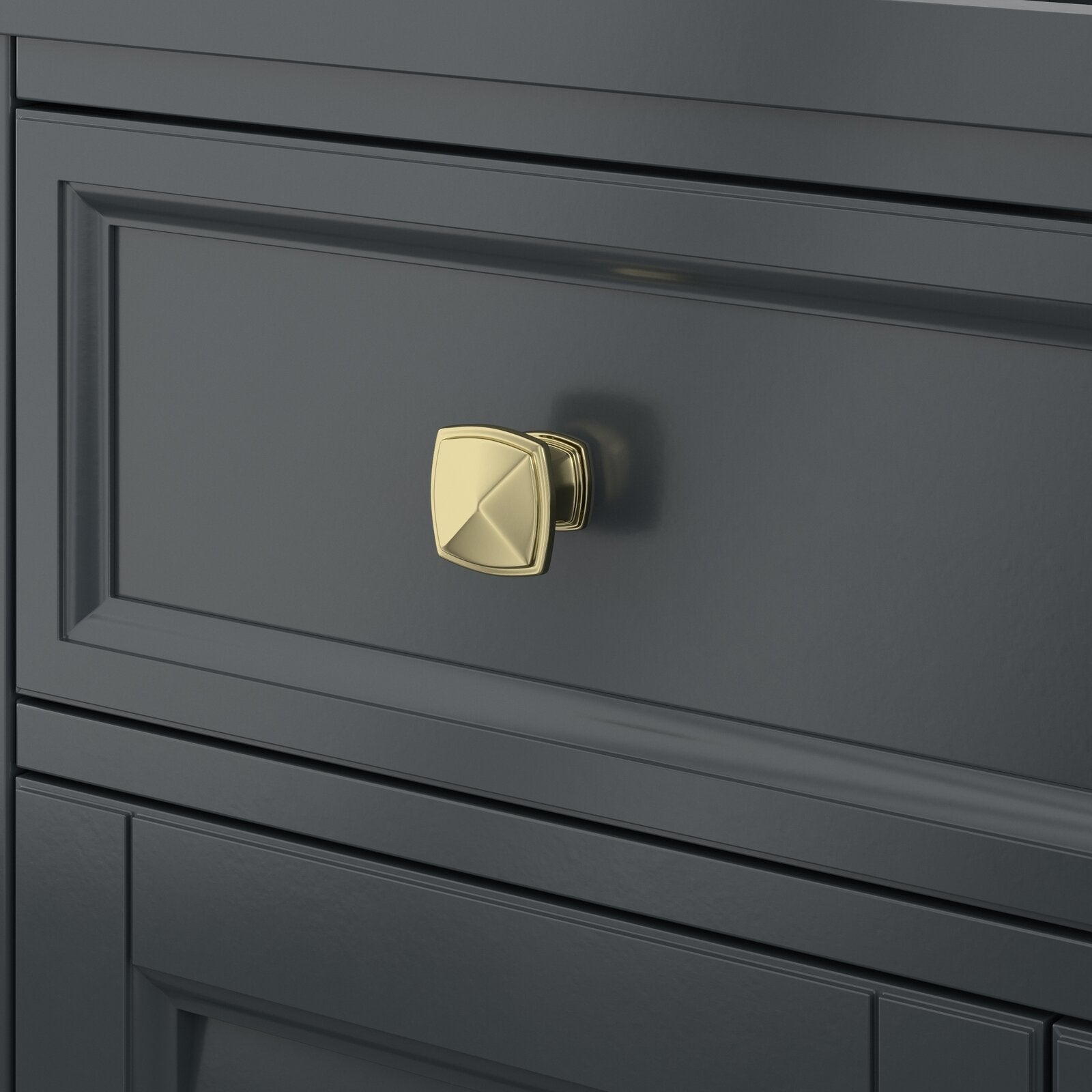 Close-up of a stone-colored solid wood bathroom vanity drawer in a modern style, showing a polished brass square knob mounted at the center of the recessed panel.
