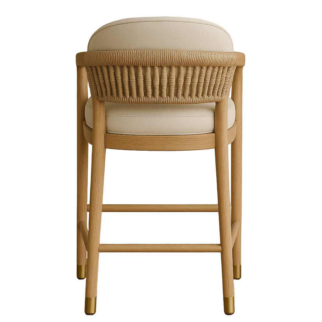 Rear view of a natural teak bar stool with woven rope back, neutral beige upholstered seat and back cushion, supportive arms and brass-capped legs in a Scandinavian coastal style.