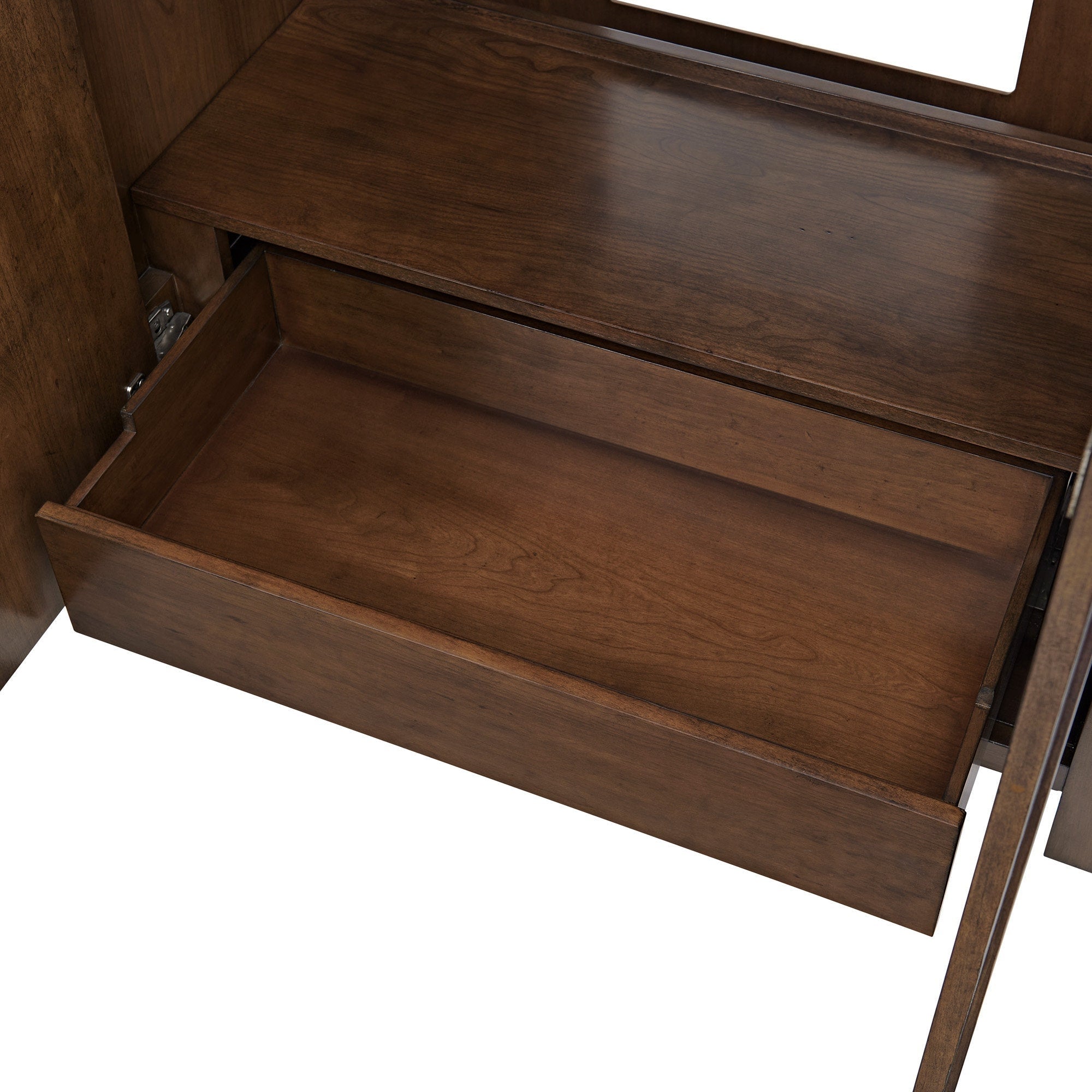 Open solid wood vanity drawer with warm brown finish and visible wood grain, showing the interior storage compartment and metal glide hardware.