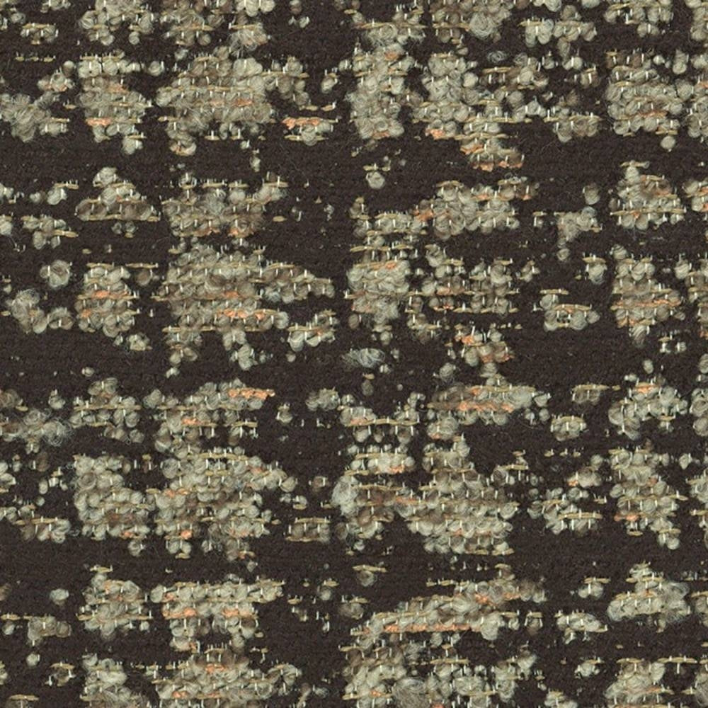 Close-up of dark woven upholstery fabric with beige and cream looped yarns and subtle orange flecks; textured contemporary fabric composed of 41% viscose, 9% acrylic and 50% polyester for sofa use.