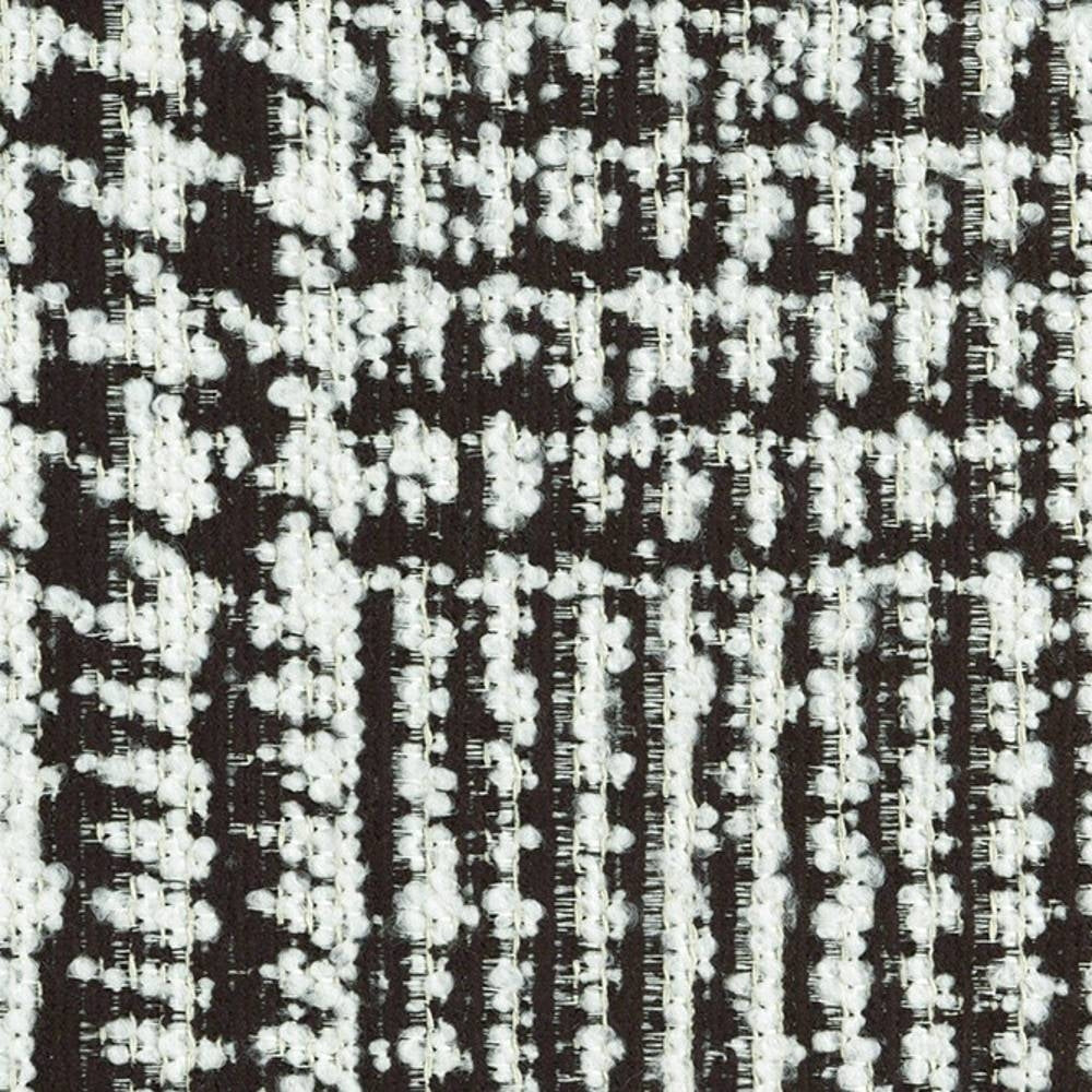Close-up of black-and-white boucle upholstery fabric showing nubby woven texture, 29% viscose / 11% acrylic / 60% polyester composition, heavy-duty and suitable for contemporary sofa upholstery.