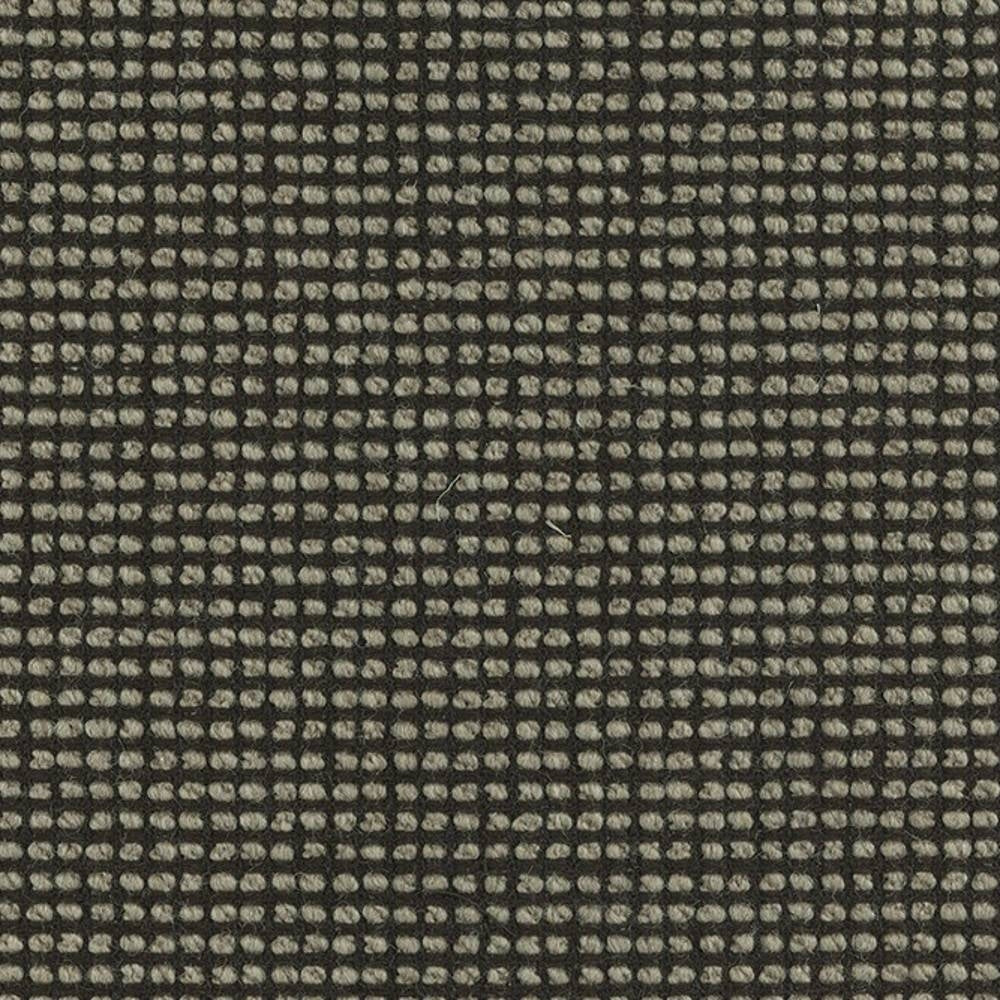 Close-up of a linen-wool blend upholstery fabric showing a small beige looped grid on a dark charcoal ground, highlighting textured yarn and a tight weave suitable for sofa upholstery.